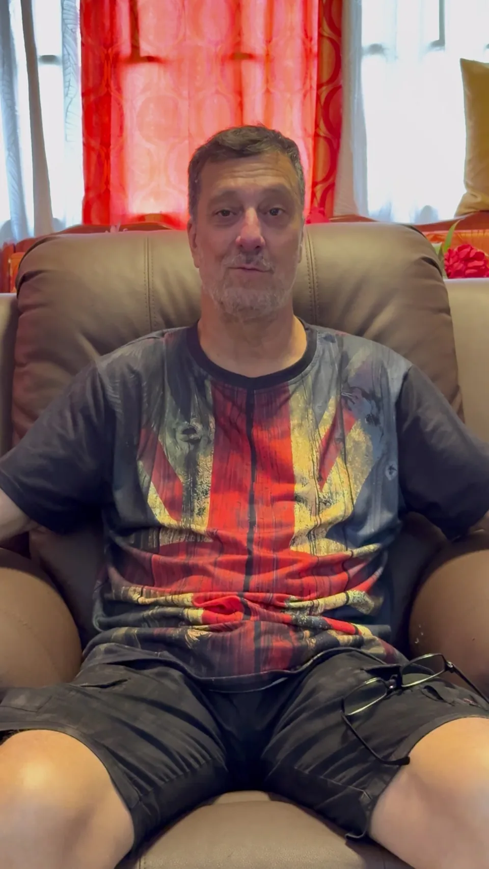 Dave M. seated in his living room, talking to camera